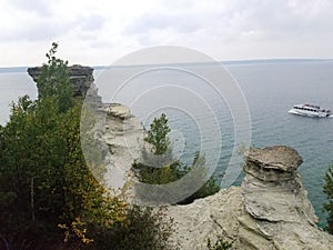 Tour Boat Sails by Rocky Pier at Miner's Castle, Landmark at Pictured Rocks National Lakeshore August 2021
