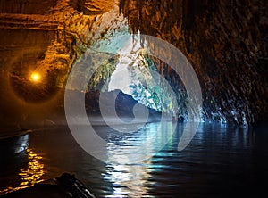 Tour by boat tourists in a cave with an underground lake Melissani on the island of Kefalonia, Greece