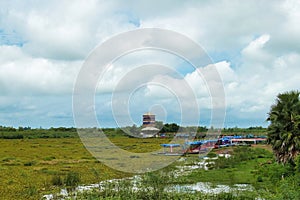 Tour boats and a lookout tower in Ban Diam, Udon Thani, Thailand