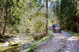 A tour group travels on ATVs and UTVs on the mountains