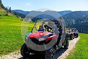 A tour group travels on ATVs and UTVs on the mountains