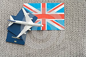 Tourim flight to the Grean Britain concept. Vacation in the United Kingdom. Composition of the UK flag, passport and toy