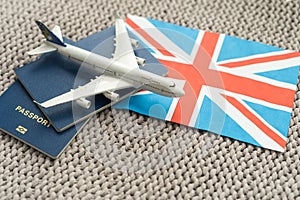 Tourim flight to the Grean Britain concept. Vacation in the United Kingdom. Composition of the UK flag, passport and toy photo