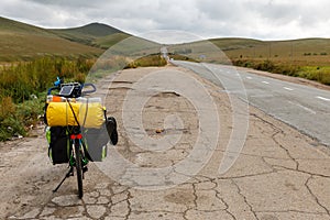 Touring bike stands near the asphalt road