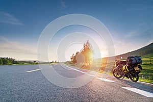 Touring motorcycle with big baggage parking on asphalt roadside