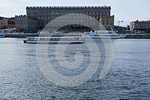 A touris boat sails in Lake MÃ¤laren in front of The Royal Palace in Stockholm, Sweden