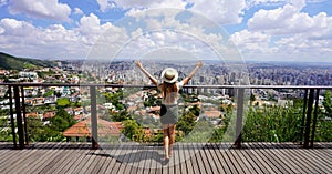 Tourism in Belo Horizonte, Brazil. Panoramic banner view of tourist woman with raising arms from beautiful belvedere in Belo photo