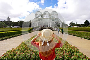 Tourism in Curitiba, Brazil. Rear view of fashion traveler girl in botanical garden of Curitiba, Parana, Brazil