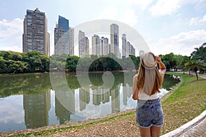 Tourism in Goiania, Brazil. Back view of beautiful girl with hat in the Parque Areiao, a city park in Goiania, Goias, Brazil