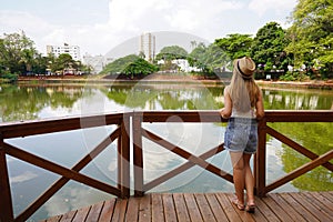 Tourism in Goiania, Brazil. Full length back view of young woman in the urban park Bosque dos buritis in Goiania, Goias, Brazil