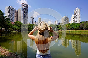 Tourism in Goiania, Brazil. Rear view of girl in the city park Vaca Brava in Goiania, Goias, Brazil