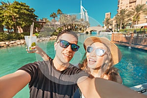 Tourism and holiday resorts - a couple in love during their honeymoon taking a selfie photo in Dubai
