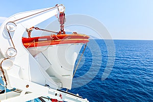 Tourism ship. Detail of the lifeboat, in the open sea, deep blue color.