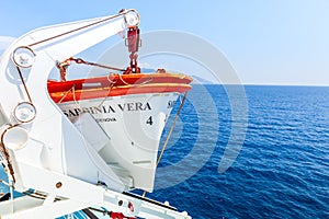 Tourism ship. Detail of the lifeboat, in the open sea, deep blue color.