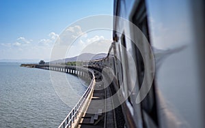 Tourism train stop on concrete bridge, Pa Sak Dam, Thailand.