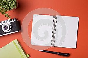 Tourism, travel concept. Office desk table with notepad, camera and supplies. Top view. Copy space for text.