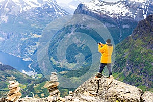 Tourist taking photo from Dalsnibba viewpoint Norway