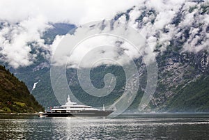 Tourism vacation and travel. Small yacht with mountains and fjord NÃ¦rÃ¸yfjord in Gudvangen, Norway, Scandinavia
