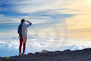 Tourist admiring breathtaking sunset views from the Mauna Kea, a dormant volcano on the island of Hawaii.