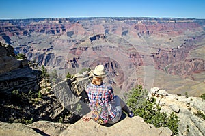 Tourist admiring multicoloured rocks with dozens of layers in Grand Canyon