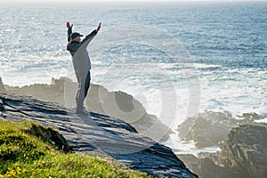 Tourist admiring scenic beauty of Malin Head, Ireland\'s northernmost point, Wild Atlantic Way, spectacular coastal route.
