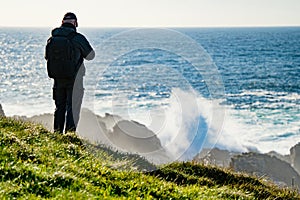 Tourist admiring scenic beauty of Malin Head, Ireland's northernmost point, Wild Atlantic Way, spectacular coastal route.