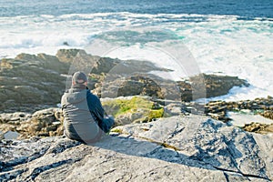Tourist admiring scenic beauty of Malin Head, Ireland\'s northernmost point, Wild Atlantic Way, spectacular coastal route.