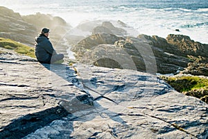 Tourist admiring scenic beauty of Malin Head, Ireland\'s northernmost point, Wild Atlantic Way, spectacular coastal route.