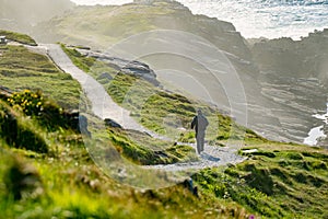 Tourist admiring scenic beauty of Malin Head, Ireland's northernmost point, Wild Atlantic Way, spectacular coastal route.