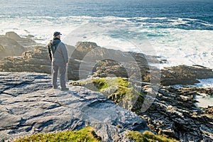 Tourist admiring scenic beauty of Malin Head, Ireland\'s northernmost point, Wild Atlantic Way, spectacular coastal route