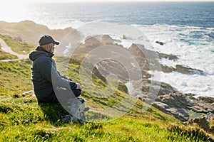 Tourist admiring scenic beauty of Malin Head, Ireland\'s northernmost point, Wild Atlantic Way, spectacular coastal route