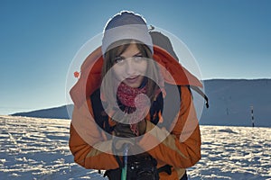 Tourist admiring the scenic view of Bucegi Carpathian Mountains in winter time