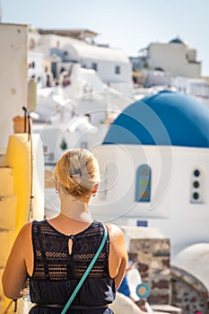 Tourist  admiring stunning Oia architecture in Santorini