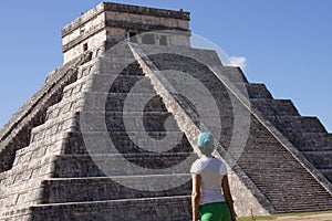 Tourist attracted by the ancient Mayan pyramid and temple of Kukulkan at Chichen-Itza, next to the Mexican village of Piste