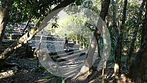 Tourist attracted by the mayan ruin of the pyramid of Nohoch Mul in Coba in the middle of the jungle of the yucatan peninsula