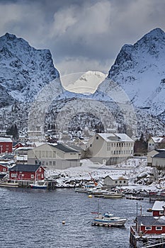 Tourist Attraction Hamnoy Fishing Village at Lofoten Islands in Norway Along With Red Rorbu Houses with High Snowy Mountains on