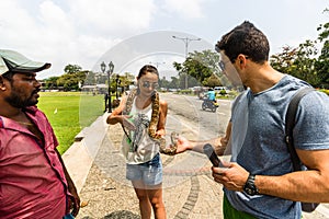 Tourist attraction, people/tourists petting a snake in Colombo, Sri Lanka, 2020