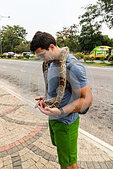 Tourist attraction, people/tourists petting a snake in Colombo, Sri Lanka, 2020