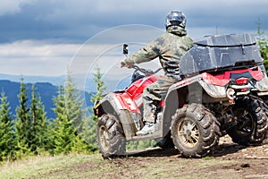 Tourist on ATV driving through the mountains