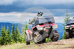 Tourist on ATV driving through the mountains