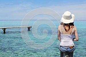 Tourist back woman in Formentera turquoise sea