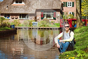 Tourist with a backpack by the canal