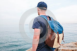 A tourist with a backpack on the coast. Travel, tourism, recreation.