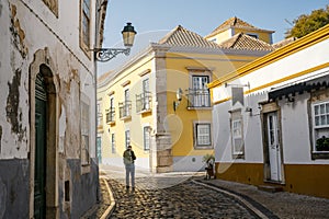 A tourist with backpack exploring Faro, Algarve, Portugal