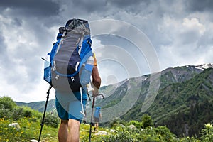 Tourist with backpack hike on mountain trek. Hiking in Svaneti, Georgia. Trekking in mountains