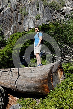 Tourist with backpack hiking in mountains