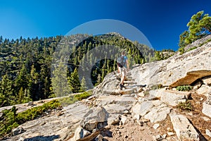 Tourist with backpack hiking in mountains