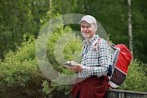 Tourist with backpack and mobile phone