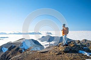 Tourist with a backpack in the mountains. Mountain hiking in the high mountains. Travel and adventure. Active life.