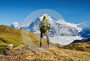 Tourist with a backpack in the mountains. Mountain hiking in the high mountains. Travel and adventure. Active life. Landscape in t